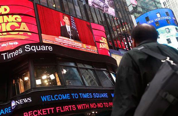 A man watches Obama's speech in Times Square.